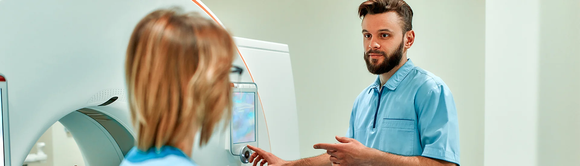 a male and female radiology nurse setting up the machinery